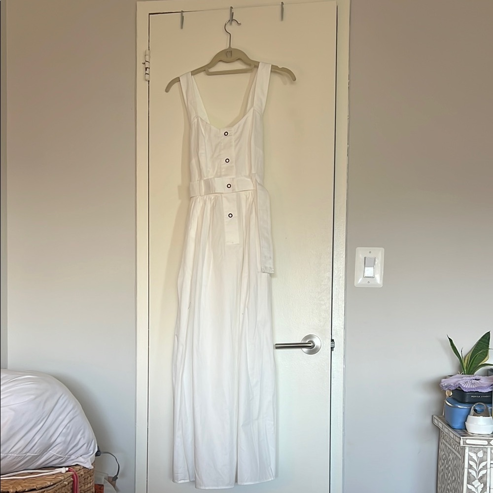 White a line poplin dress with button detail and cross cross straps at the back